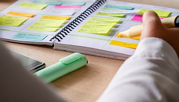 Person organizing her schedule on full calendar