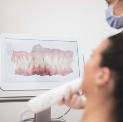 Patient and orthodontic team member looking at computer monitor