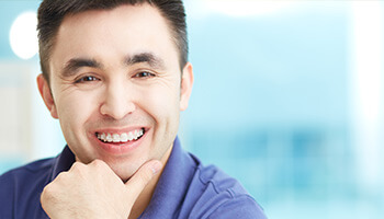 man wearing purple shirt smiling