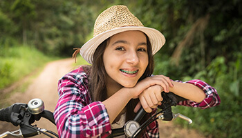 young woman smiling on bike