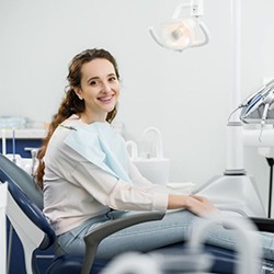 Woman with braces sitting upright in dental treatment chair