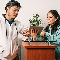 Patient talking with orthodontic team member at front desk