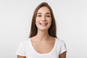 Woman smiling after appointment to repair broken braces