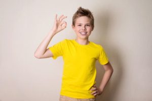 Smiling boy with braces undergoing phase 1 orthodontics