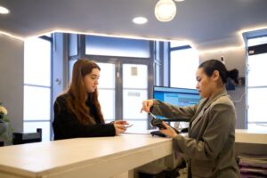 Dental team member accepting payment from patient 
