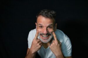 Mature, smiling man wearing dental braces